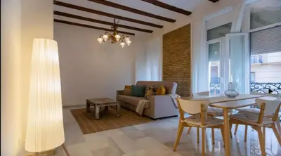 a living room with a table and chairs and a couch at Your apartment in the heart of Valencia in Valencia