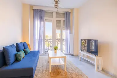a living room with a blue couch and a table at Apartment in the center of Valencia in Valencia