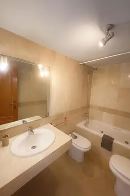 a bathroom with a sink and a toilet and a tub at Cortes Suite - Pool paddle tennis court and gym in Valencia