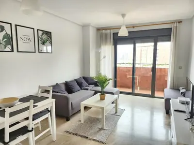 a living room with a couch and a table at Cortes Suite - Pool paddle tennis court and gym in Valencia
