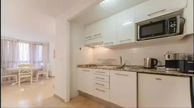 a kitchen with white cabinets and a microwave at Historic Center - Loft in the heart of Valencia in Valencia