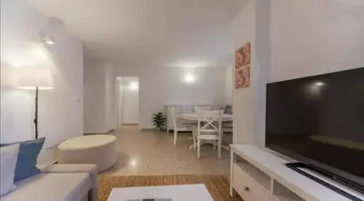 a living room with a couch and a television at Historic Center - Loft in the heart of Valencia in Valencia