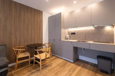 a kitchen with a counter and a table and chairs at Rice Museum Apartments in Valencia