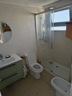 a bathroom with a toilet and a shower and a sink at Casa Xalera in Mareny Barraquetas