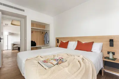 a bedroom with a large white bed with red pillows at B48 Valencia Feria in Valencia