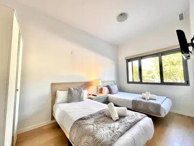 a bedroom with two beds and a couch at Turia view apartment in Valencia