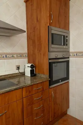 a kitchen with a microwave and a counter top at Your Paradise with Pool - 2 min from Beach in Moncófar