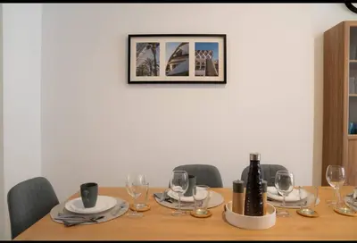 a wooden table with glasses and a bottle of wine at Hermoso apartamento en Nazaret in Valencia
