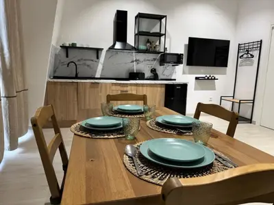 a wooden table with plates on it in a kitchen at El Jardín de Darío in Valencia