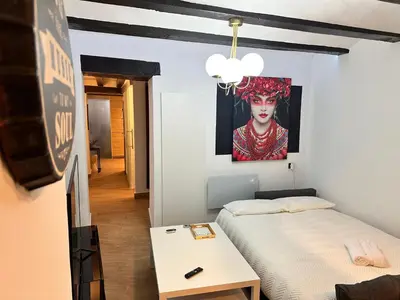 a bedroom with a bed and a painting on the wall at Central House with Terrace in Valencia