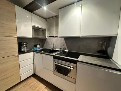a kitchen with white cabinets and stainless steel appliances at Central House with Terrace in Valencia