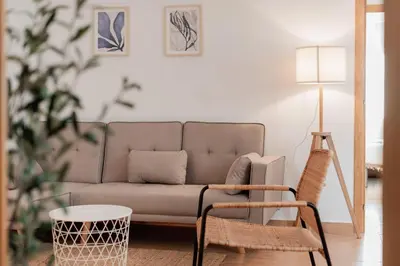 a living room with a couch and a lamp at Apartamentos FV Flats Valencia - Mestalla 5 in Valencia