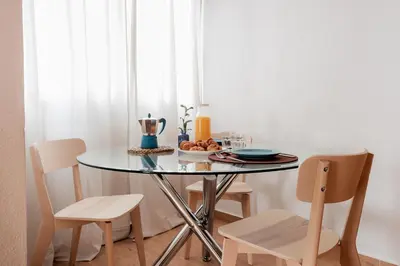 a table with chairs and a bowl of food on it at Apartamentos FV Flats Valencia - Mestalla 5 in Valencia