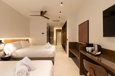 a hotel room with two beds and a flat screen tv at Moontels Colón in Valencia