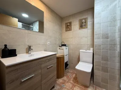 a bathroom with a toilet and a sink at Apartmento en 5 Mares in Puebla de Farnals