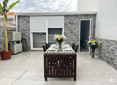 a table with flowers on it on a patio at Casa moderna en Manises con 2 terrazas in Manises