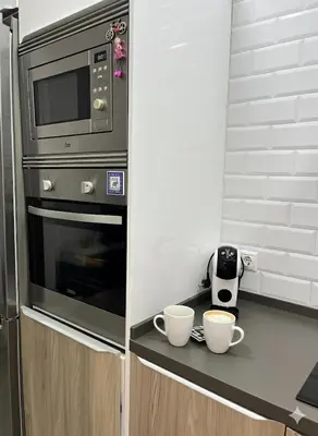 a kitchen with two cups on a counter with a microwave at Casa moderna en Manises con 2 terrazas in Manises