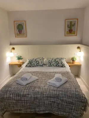 a bedroom with a bed with two towels on it at Casa Albacora 1892 in Losa del Obispo