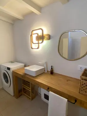 a bathroom with a sink and a mirror on the wall at Casa Albacora 1892 in Losa del Obispo