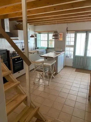 a kitchen with a table and chairs in a room at Casa Albacora 1892 in Losa del Obispo