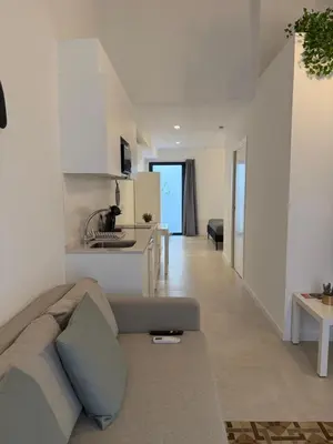 a living room with a couch and a kitchen at K&A Apartments in Valencia