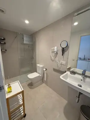 a bathroom with a toilet and a shower and a sink at K&A Apartments in Valencia