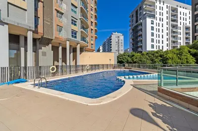 a swimming pool in a city with tall buildings at GuestReady – Modern Flat with Terrace in Valencia in Valencia
