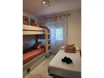 a bedroom with two bunk beds and a window at Apartment in Vera with rooftop pool in Valencia