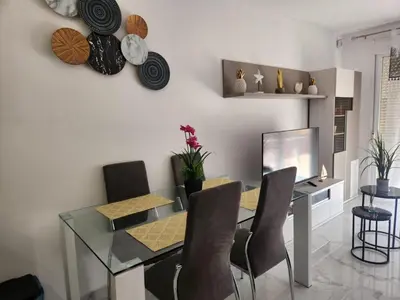 a dining room with a glass table and chairs at Apartment in Vera with rooftop pool in Valencia