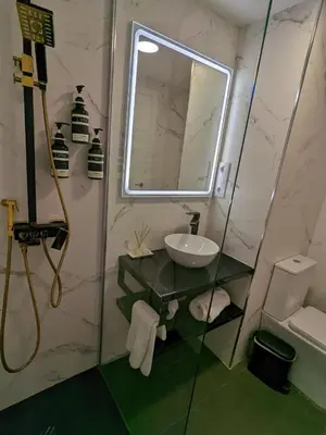 a bathroom with a sink and a mirror at Hotel Catalina Suites in Valencia