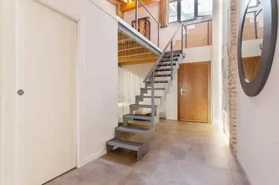 a staircase in a house with a mirror on the wall at Bolseria Ciutat Vella in Valencia