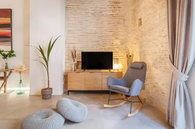 a living room with a chair and a television at Bolseria Ciutat Vella in Valencia