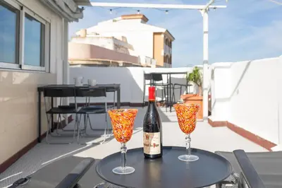 a bottle of wine and two glasses on a table at Seaview Apartment N12 in El Perelló