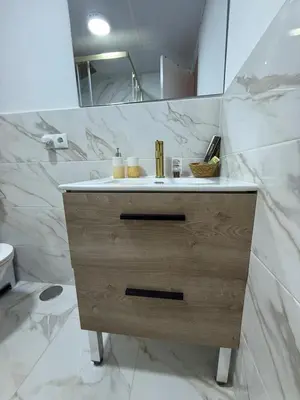 a bathroom with a sink and a mirror at Duplex Ático con terraza y BBQ in Puerto de Sagunto