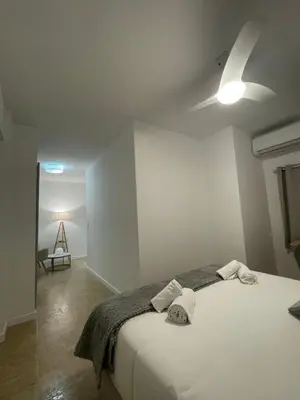 a bedroom with a bed with two towels on it at Valentia Rooms - Baleares in Valencia