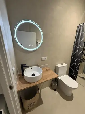 a bathroom with a sink and a mirror and a toilet at Glamour Suite 2 next to the city center in Valencia