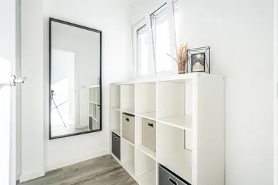 a dressing room with white shelves and a mirror at Duplex-Port-Valencia 14 in Valencia