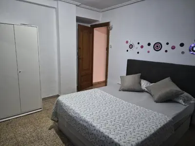 a bedroom with a bed with a white comforter at democracia delux in Valencia