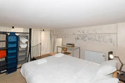 a bedroom with a white bed and a desk at GuestReady - Urban Loft in Valencia in Valencia