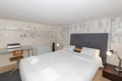a bedroom with a large white bed and a desk at GuestReady - Urban Loft in Valencia in Valencia