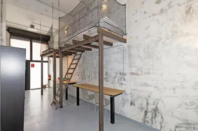 a staircase in a room with a wooden table and a wall at GuestReady - Urban Loft in Valencia in Valencia