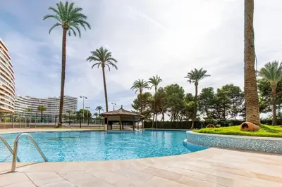 a swimming pool with palm trees and a gazebo at Florazar 2 Pool & Private Balcony in Cullera