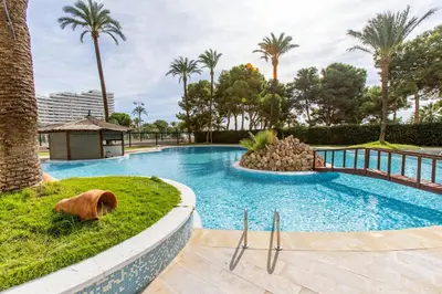 a swimming pool in a resort with palm trees at Florazar 2 Pool & Private Balcony in Cullera