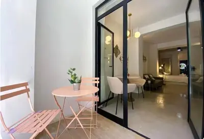 a dining room with a table and chairs and a room at Cosy apartment between beach and city centre in Valencia