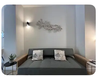 a living room with a couch with two pillows at Cosy apartment between beach and city centre in Valencia