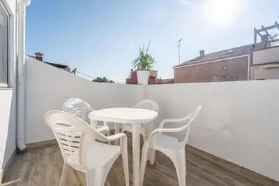 a white table and chairs on a balcony at Duplex-Port-Valencia in Valencia