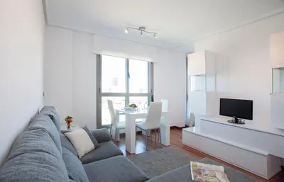 a living room with a couch and a table at SingularStays Oceanic in Valencia