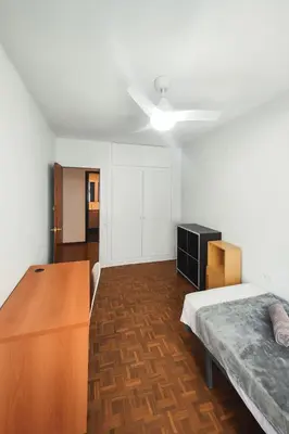 a bedroom with a bed and a dresser in it at Apartamento Familiar En Nuevo Centro - Parque Central Turia in Valencia