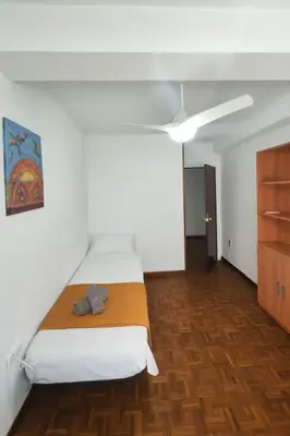 a bedroom with a bed and a ceiling at Apartamento Familiar En Nuevo Centro - Parque Central Turia in Valencia