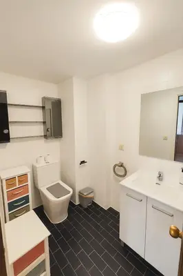 a bathroom with a toilet and a sink at Apartamento Familiar En Nuevo Centro - Parque Central Turia in Valencia